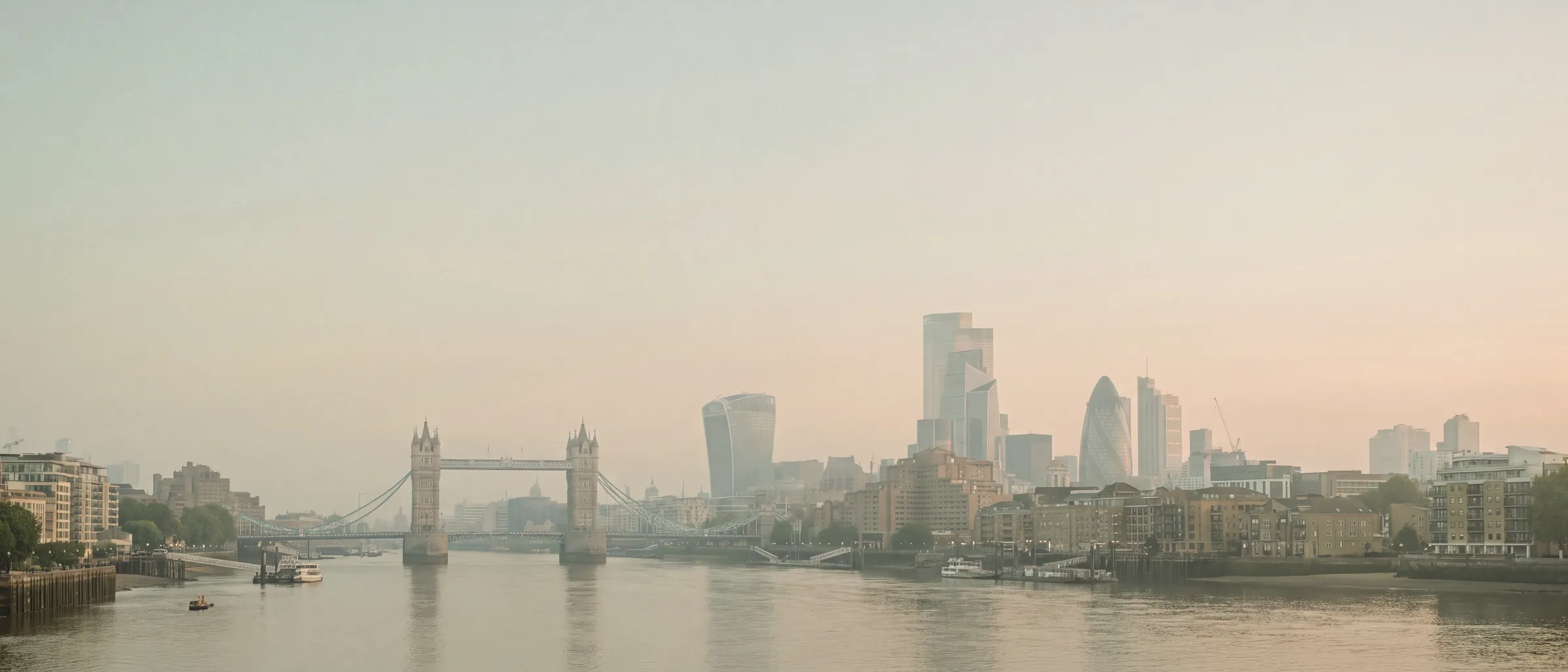 A soft hazy London skyline with Tower Bridge, the Gherkin and the Thames in pastel light